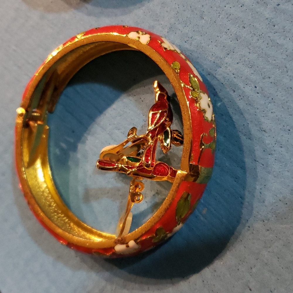 Red bangle and red clip earrings